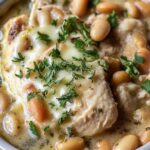 White chicken chili simmering in a large pot on stovetop