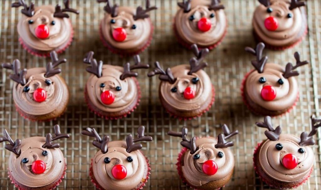 Kids making easy reindeer cupcakes in kitchen with decorating supplies and finished treats