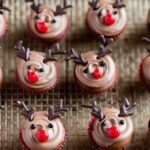 Kids making easy reindeer cupcakes in kitchen with decorating supplies and finished treats