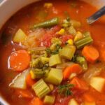 Easy vegetable soup in white bowl with crusty bread