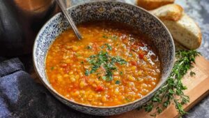 Bowl of Italian lentil soup garnished with parsley and parmesan cheese