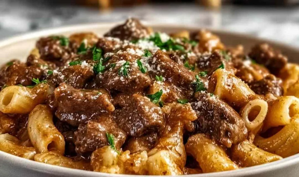 reamy garlic beef pasta served on white plate with fresh parsley garnish