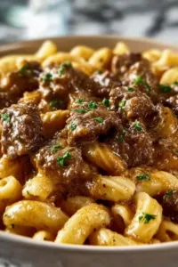 reamy garlic beef pasta served on white plate with fresh parsley garnish
