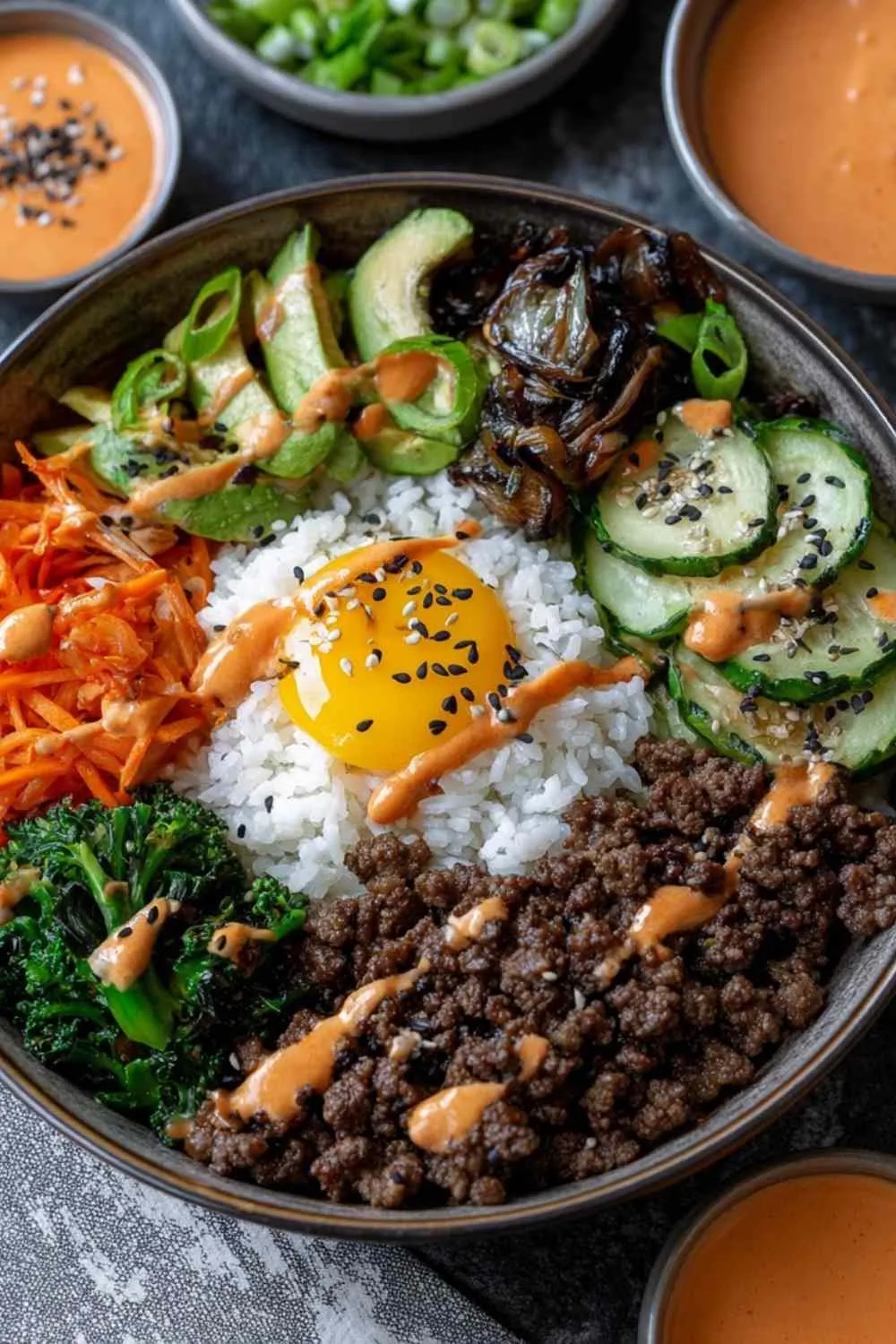 Ground beef bulgogi bowls with kimchi sauce and rice on white plate