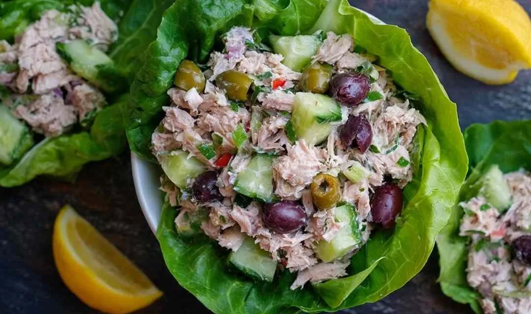 Healthy tuna salad in white bowl with celery pickles and Greek yogurt