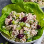 Healthy tuna salad in white bowl with celery pickles and Greek yogurt