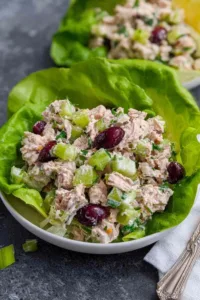 Healthy tuna salad in white bowl with celery pickles and Greek yogurt