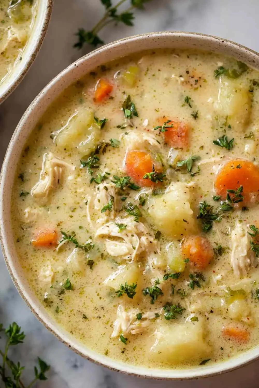 High protein chicken pot pie soup in bowl with creamy broth