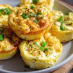 High protein cottage cheese egg bites on white plate with fresh vegetables