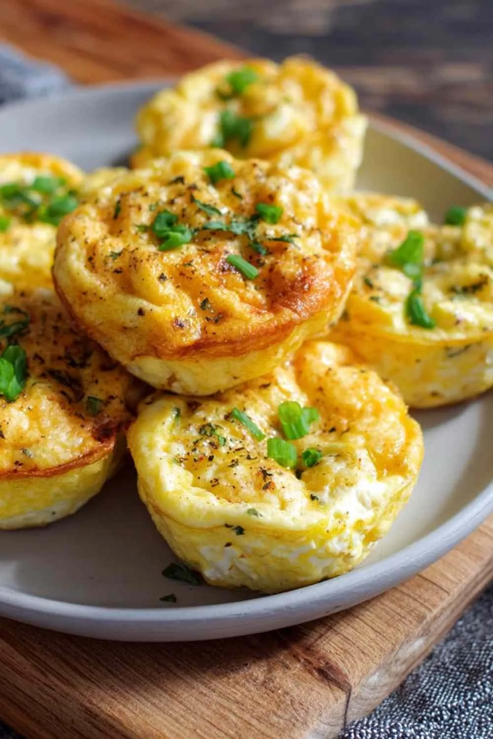High protein cottage cheese egg bites on white plate with fresh vegetables