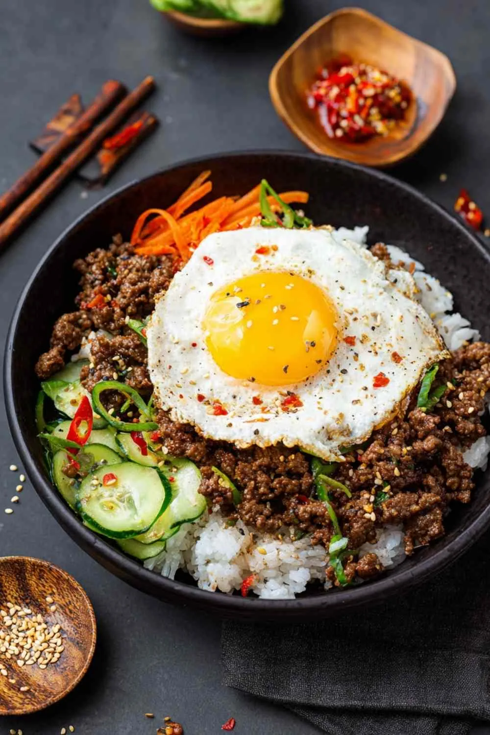 High protein chili in white bowl topped with Greek yogurt and green onions