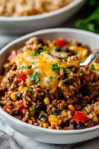 High protein unstuffed peppers in baking dish with melted cheese and colorful peppers