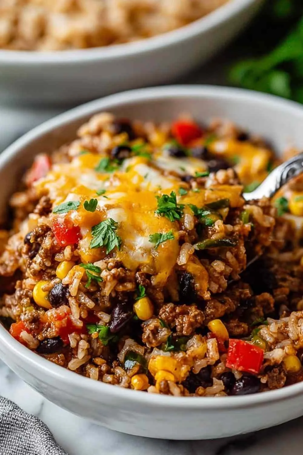High protein unstuffed peppers in baking dish with melted cheese and colorful peppers