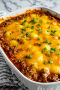 Hobo casserole with ground beef, layered potatoes, and melted cheddar cheese fresh from the oven
