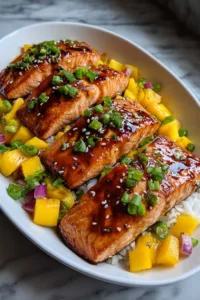Mango Teriyaki Salmon on white plate with rice and vegetables