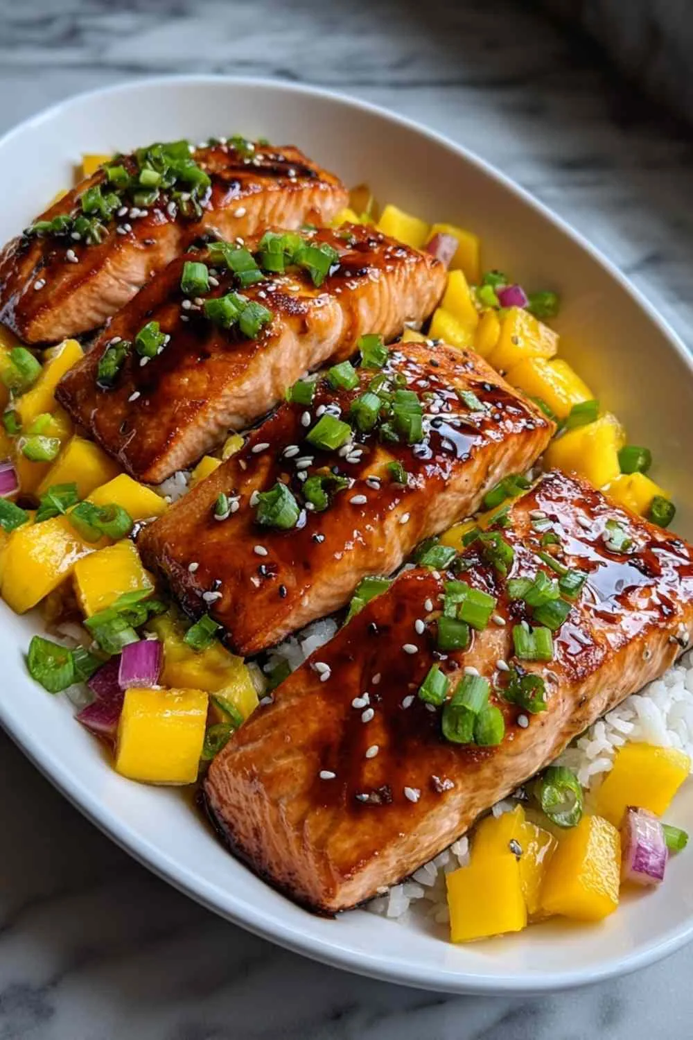 Mango Teriyaki Salmon on white plate with rice and vegetables