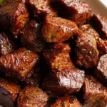 Air fryer steak bites served with dipping sauces and vegetables