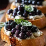Balsamic blueberry goat cheese crostini on serving platter