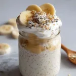 Spoon lifting creamy banana cream pie overnight oats from bowl