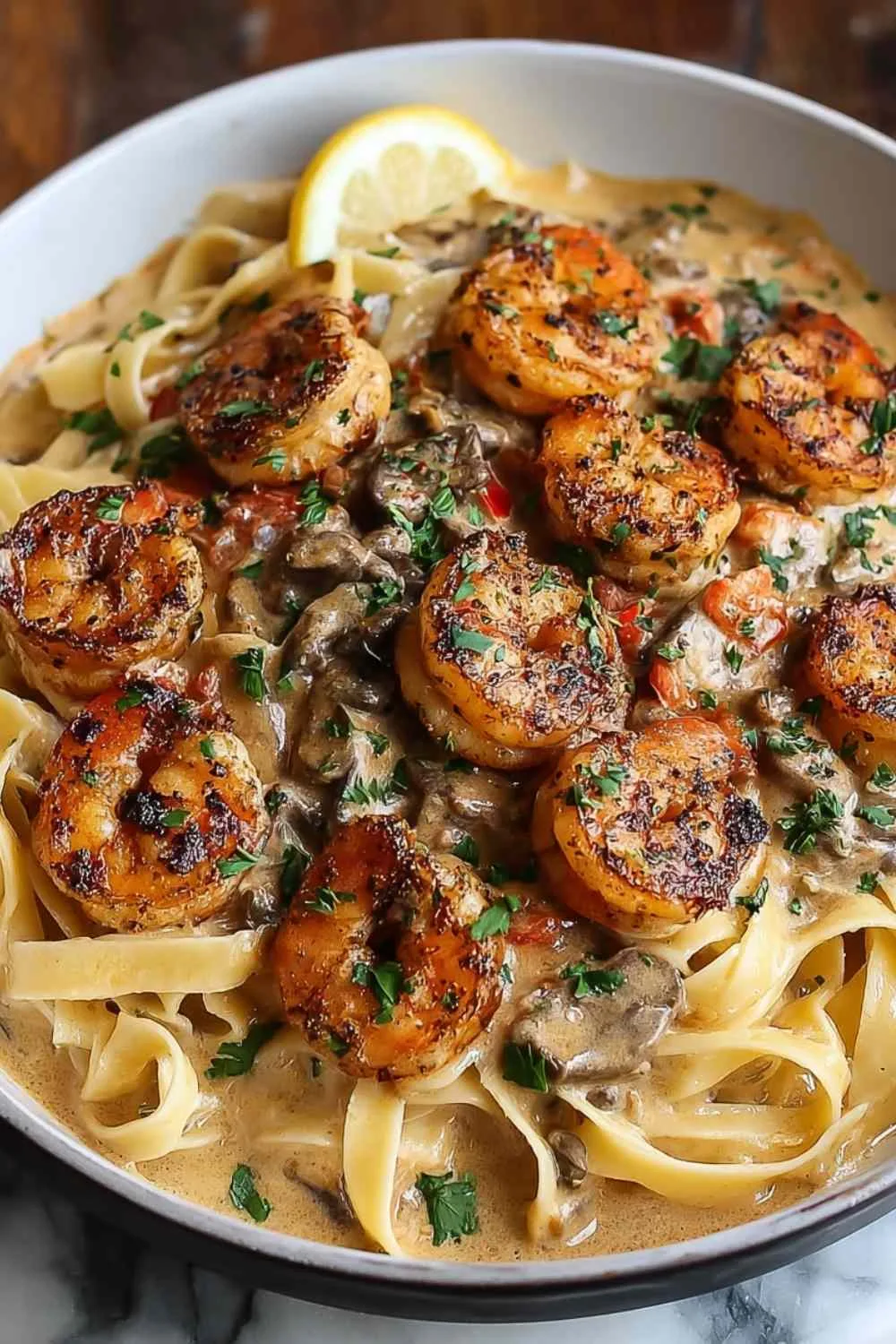 Creamy stroganoff sauce with mushrooms and red peppers in frying pan