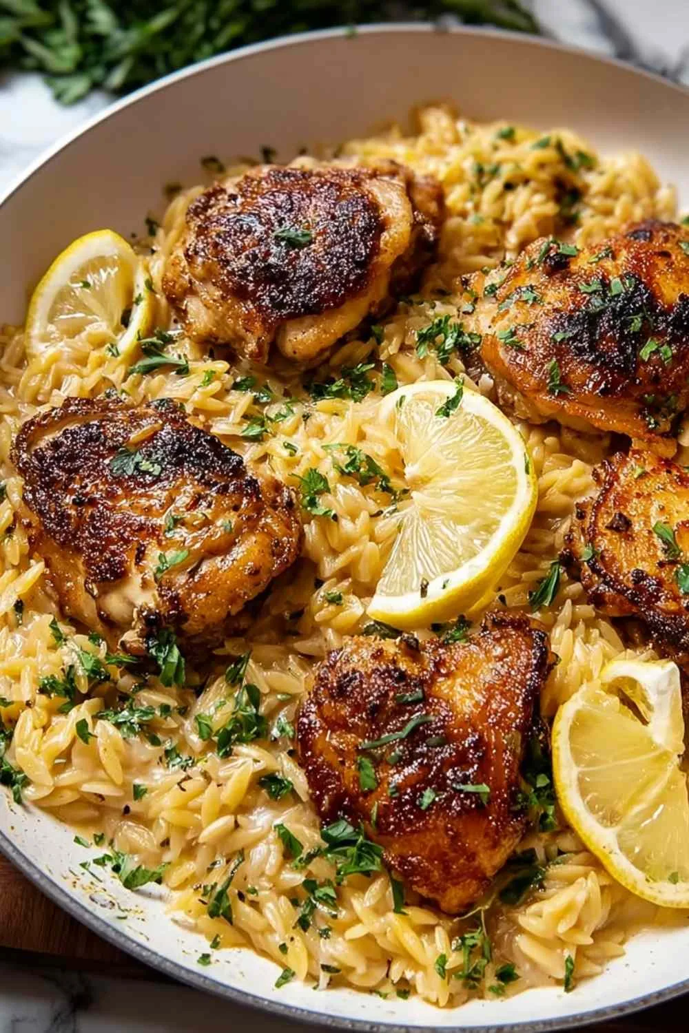 Searing seasoned chicken thighs in hot skillet for chicken thighs creamy lemon garlic orzo recipe