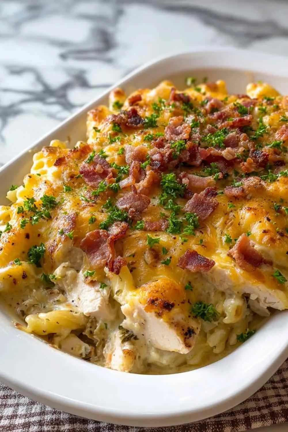 Creamy crack chicken casserole serving with pasta and bacon bits