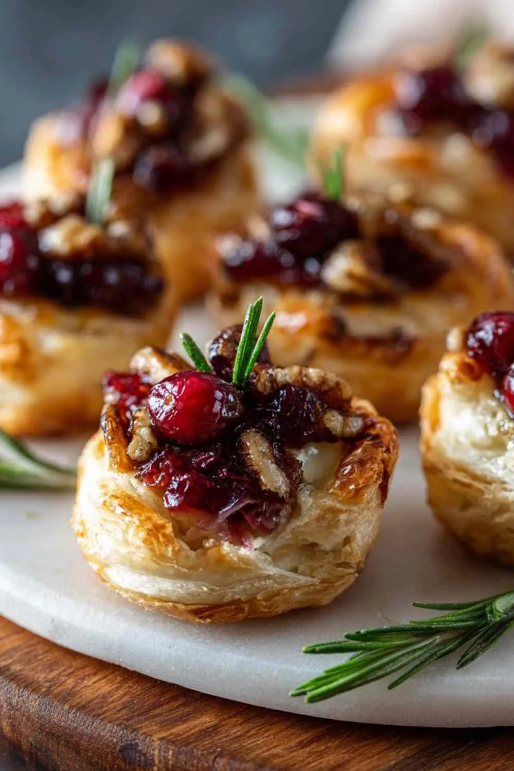 Close up of cranberry brie bite showing melted cheese and cranberry sauce filling