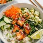 Complete crispy salmon bowl with fresh vegetables, rice and sesame seeds