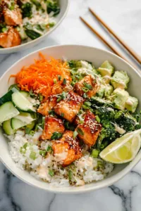Complete crispy salmon bowl with fresh vegetables, rice and sesame seeds
