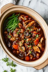 Bourbon chicken meal with steamed broccoli and cauliflower rice on white plate