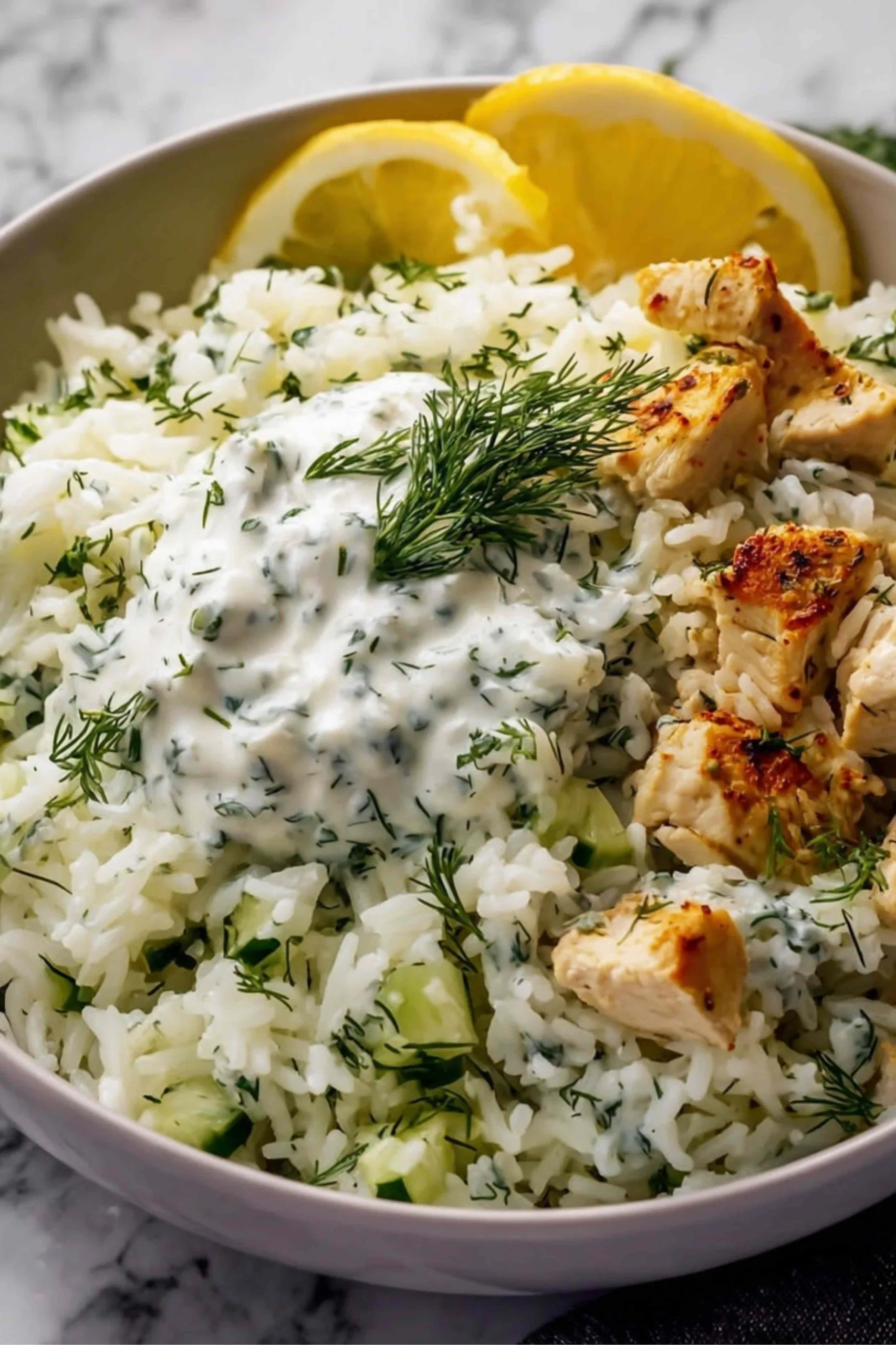 Close up of Dump and Bake Chicken Tzatziki Rice showing creamy sauce and tender chicken
