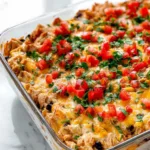 Single serving of chicken burrito casserole with cilantro and avocado garnish