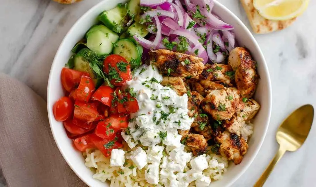 Chicken gyro bowl with marinated chicken, feta cheese, cucumbers, tomatoes, and tzatziki sauce