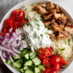 Meal prep containers with chicken gyro bowl components separated