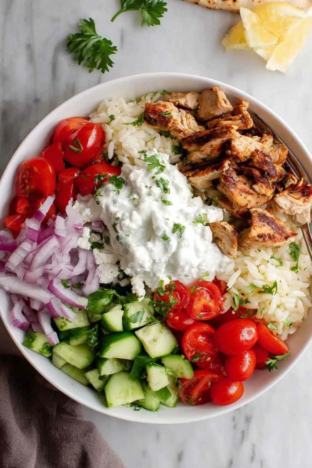 Meal prep containers with chicken gyro bowl components separated