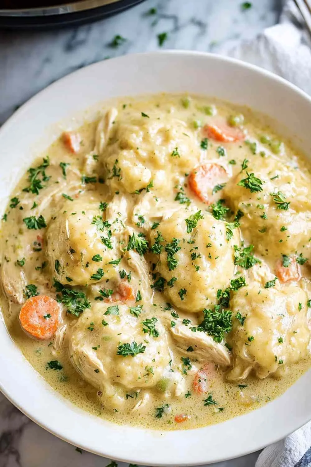 Bowl of homemade crockpot chicken and dumplings served hot