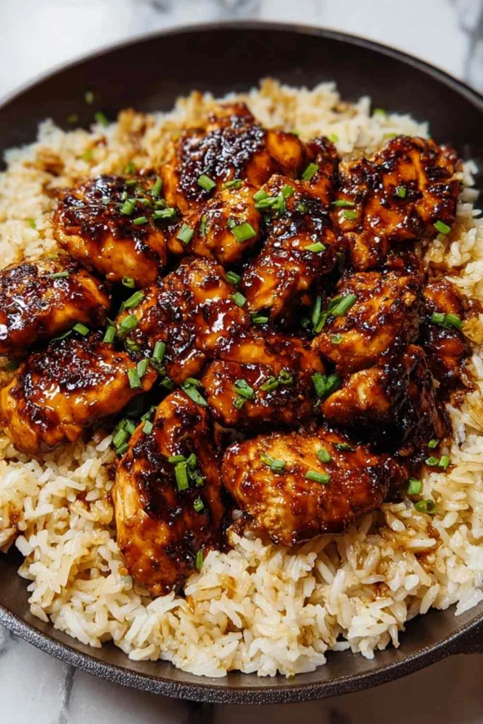 Plated serving of one-pan honey BBQ chicken and rice with fresh parsley garnish