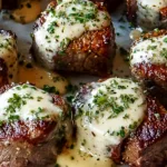 Garlic butter steak bites with Parmesan cream sauce served over mashed potatoes