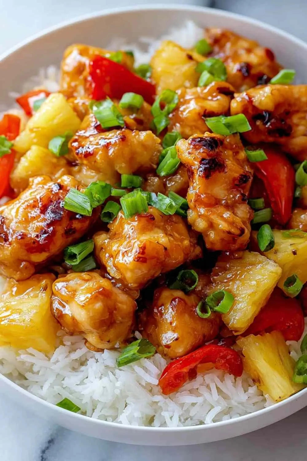 Plated Hawaiian Pineapple Chicken dinner with jasmine rice and fresh cilantro