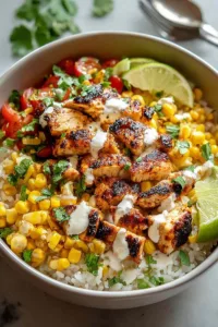 Street Corn Chicken Rice Bowl with grilled chicken, charred corn, avocado and cilantro in white bowl