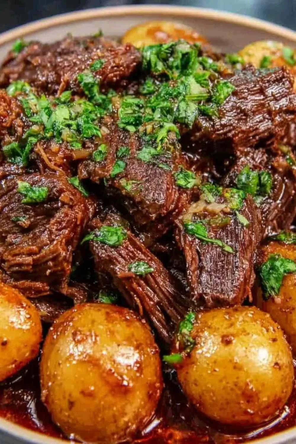 Slow cooker garlic butter beef with potatoes garnished with fresh parsley Filename: slow-cooker-garlic-butter-beef-with-potatoes.jpg