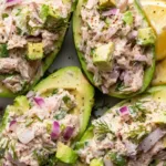 Avocado Tuna Salad Boats served on a white plate for a healthy lunch.