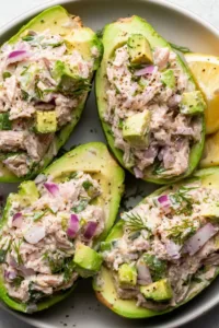 Avocado Tuna Salad Boats served on a white plate for a healthy lunch.