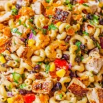 A colorful bowl of BBQ Chicken Pasta Salad with juicy chicken, black beans, and bell peppers.