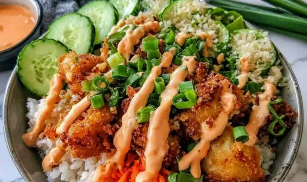 Bang Bang Chicken Rice Bowl with crispy chicken tenders and creamy bang bang sauce