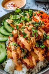 Bang Bang Chicken Rice Bowl with crispy chicken tenders and creamy bang bang sauce