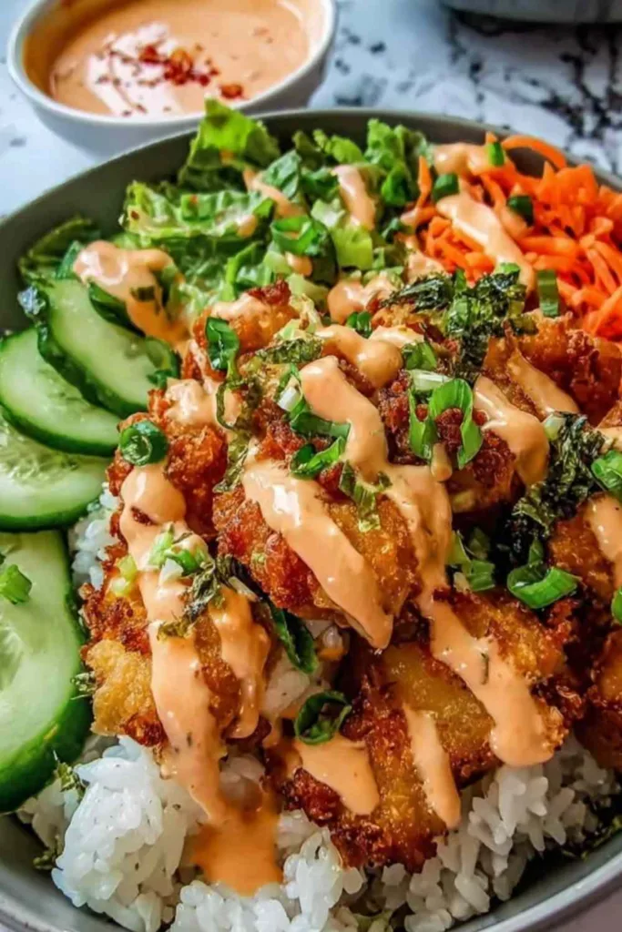Bang Bang Chicken Rice Bowl with crispy chicken tenders and creamy bang bang sauce