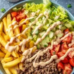 Big Mac Bowls served in a white bowl with special sauce drizzle