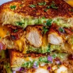 Chicken Avocado Melt Sandwich with melted cheese and fresh avocado slices on sourdough bread.