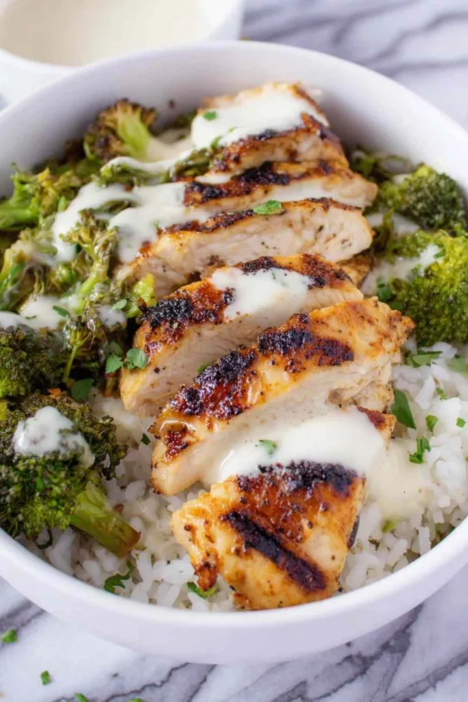 Chicken and Broccoli Bowls with Creamy Garlic Sauce in white bowls
